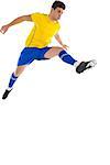 Football player in yellow jumping on white background