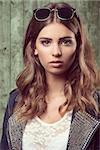 close-up portrait of pretty girl with casual autumn fashion style, sunglasses on the head and lace shirt. Wavy natural hair