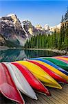 Landscape view of Moraine lake with colorful boats foreground, Canadian Rocky Mountains