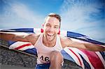 Track and field athlete cheering with British flag