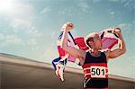 Track and field athlete holding British flag