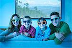 Family wearing 3D glasses in living room