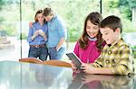 Family using technology in kitchen