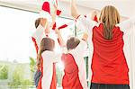 Family in sports jerseys cheering together