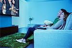 Couple watching television in living room