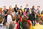 Business people clapping around businesswoman