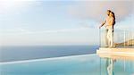 Couple overlooking ocean from modern balcony