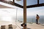 Couple standing on balcony of modern home