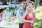 Laughing couple hugging outdoors