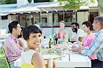 Woman smiling at table outdoors