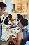 Couple talking at dinner party