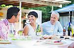 Friends relaxing at table outdoors