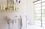 Sink and towel rack in rustic bathroom