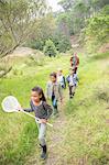 Students and teacher walking on dirt path