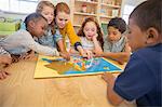 Children and teacher playing in class