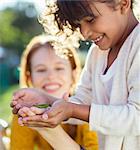 Mother and daughter examining insect