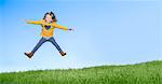 Girl jumping for joy on grassy hill