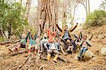 Students and teachers cheering in forest