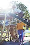 Teacher watching student play on play structure