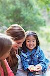 Teacher and student examining plants outdoors