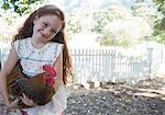 Girl holding chicken at petting zoo