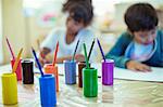 Colored pencils on desk in classroom