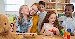 Students and teacher playing in classroom