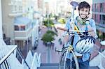 Man carrying bicycle on city steps