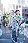 Man carrying bicycle on city steps