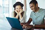 People working together on laptop in office