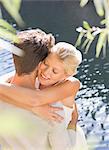 Couple hugging by pool