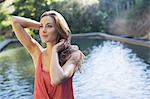 Woman standing by pool outdoors