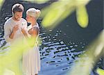 Couple drinking champagne by pool