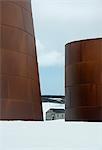 Tall rusting metal whale oil tanks at the former whaling station on Deception Island.