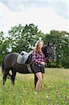 Close-up portrait of a young woman with a Arab-Haflinger horse in a meadow in summer, Upper Palatinate, Bavaria, Germany