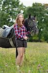 Close-up portrait of a young woman with an Arab-Haflinger horse in a meadow in summer, Upper Palatinate, Bavaria, Germany