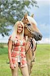 Close-up portrait of a young woman standing beside her Haflinger horse in summer, Upper Palatinate, Bavaria, Germany