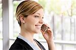 Portrait of young businesswoman chatting on cellphone