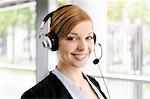 Portrait of young businesswoman in telephone headset