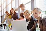 Businessman and businesswomen discussing documents at brainstorming meeting