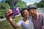 Young couple taking selfie with smartphone, Bethesda fountain, Central Park, New York City, USA