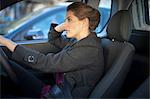 Young businesswoman driving in traffic congestion