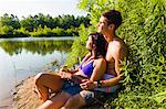 Young couple sitting on canal bank, Delaware Canal State Park, New Hope, Pennsylvania, USA