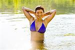 Portrait of young woman posing in river