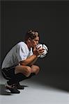 Soccer Player Crouching With Ball