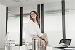 Mid adult businesswoman sitting in conference room