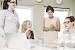 Four businesswomen at presentation meeting in conference room