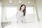 Young businesswoman laughing at laptop