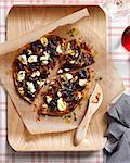 Caramelized onion pizza on chopping board