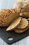 Seed bread with rolled oats, partly sliced